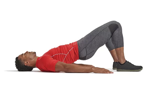 A person performing Glute Bridges