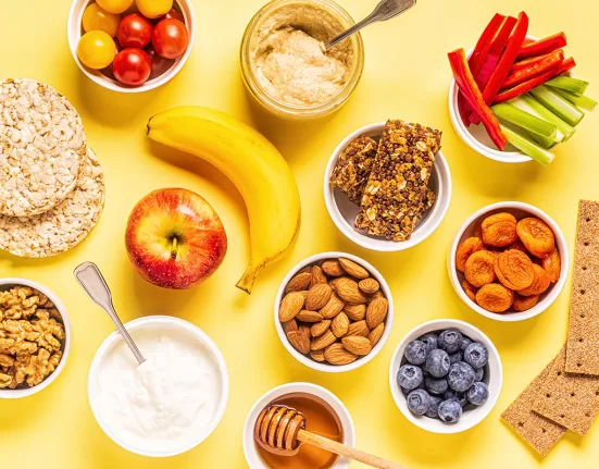 A colorful mix of roasted chickpeas, berries, and spiced nuts, representing Healthy Snacks That Taste Good.