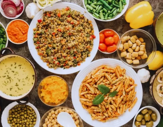 A plate featuring two types of high-protein Indian breakfast: a savory Besan Cheela and a bowl of mixed sprouts Usal, representing a satisfying High Protein Indian Vegetarian Breakfast.