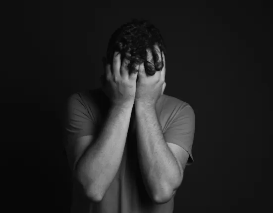 A person practicing a grounding technique (touching an object) for Managing Anxiety Attacks.