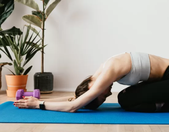 A person demonstrating the Cat-Cow stretch, a key move in the Full Body Mobility Routine For Stiff Body.