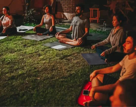 A person focusing on a candle flame (Trataka), a key Advanced Meditation Technique.