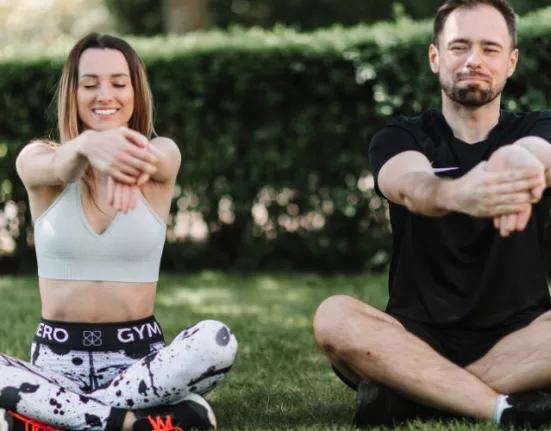 A person performing leg swings, a key part of the Dynamic Warm-Up Routine Before Workout.