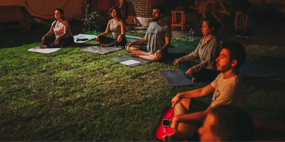 A person focusing on a candle flame (Trataka), a key Advanced Meditation Technique.