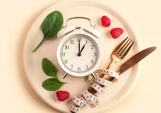 A clock showing a 16:8 fasting window next to a plate of traditional Indian food (e.g., Moong Dal Soup), illustrating the Indian Intermittent Fasting Guide.
