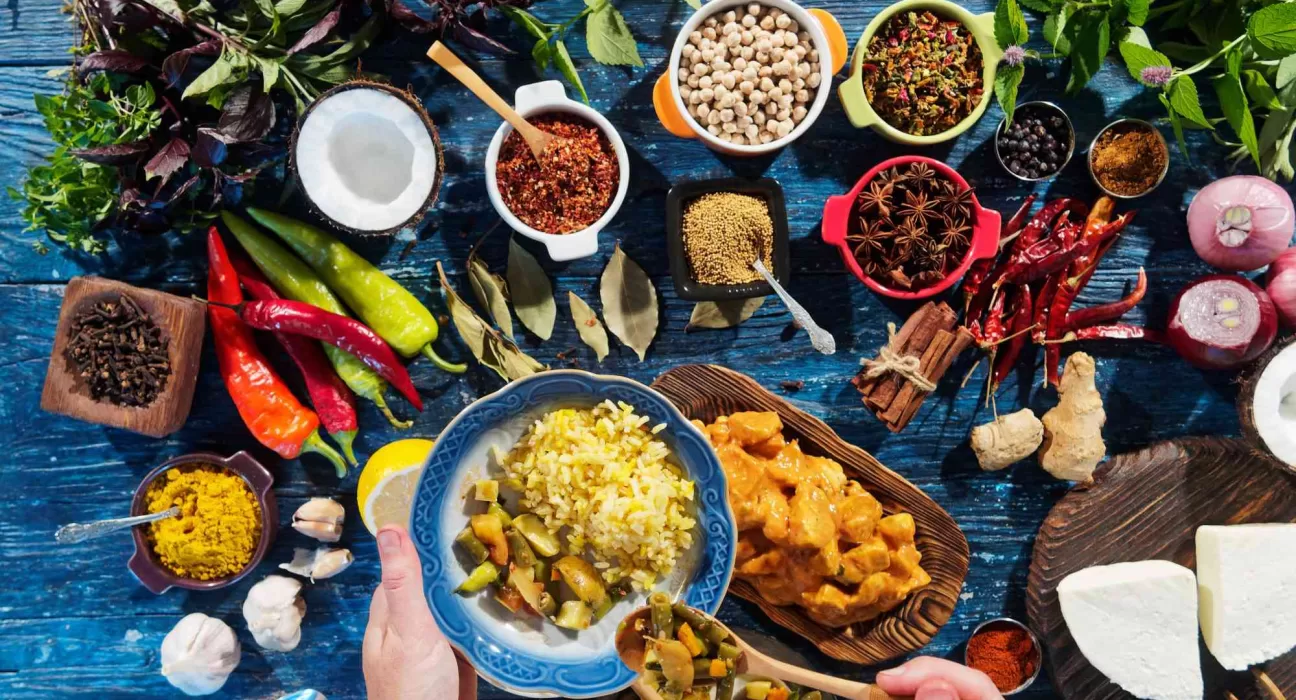 A bowl of Ashwagandha Ksheera Pak (spiced milk) next to Ayurvedic herbs, representing Ayurveda Recipes to Boost Muscles.
