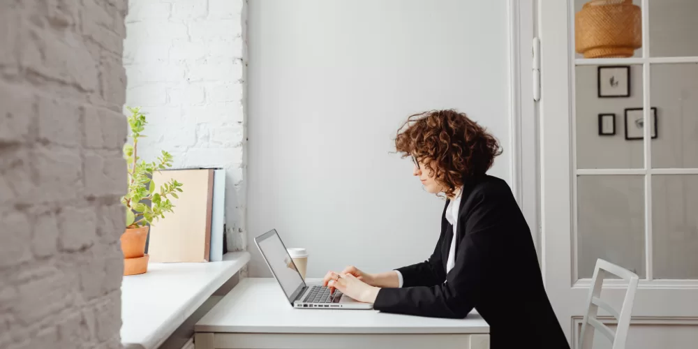 A desk worker demonstrating the proper chair and monitor setup, following the Posture Correction Guide for Desk Workers.