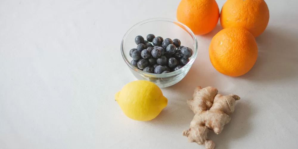 A collection of fruits and vegetables rich in the Vitamins to Boost Your Immunity (Citrus, Spinach, Eggs).