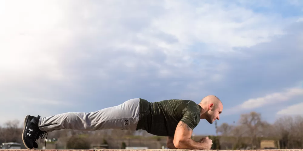 A person performing the Bird-Dog exercise, a key one among the Exercises to Fix Lower Back Pain.
