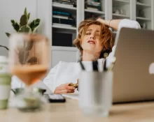A person meditating next to a neatly organized budget sheet, symbolizing Financial Habits for Stress-Free Living.