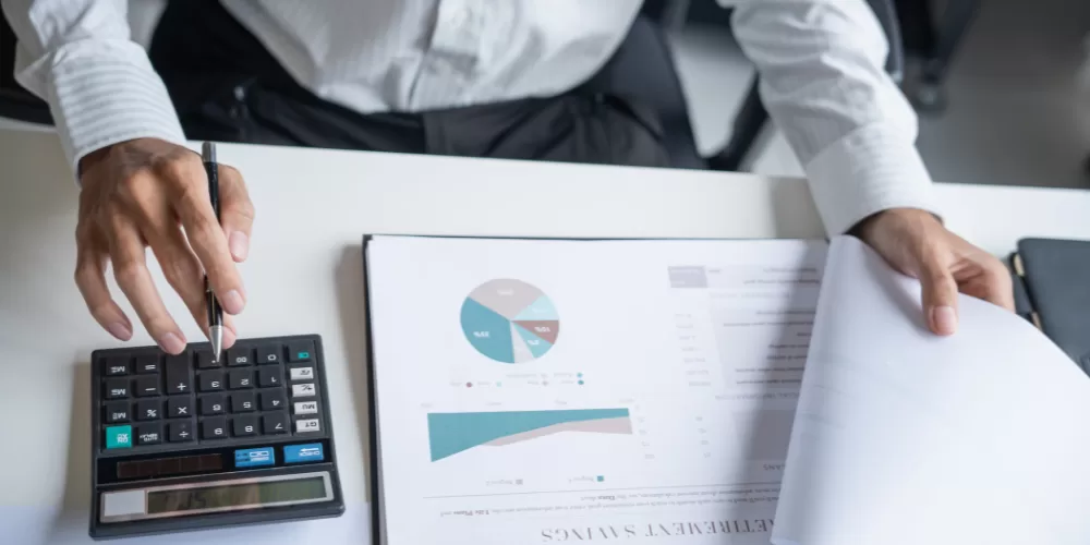 A person looking confidently toward a mountain peak, symbolizing the journey with the right Mindsets for Building Wealth.