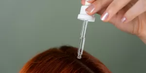 A woman running her fingers through long, thick hair, symbolizing the success of Ayurvedic Herbs for Hair Growth.