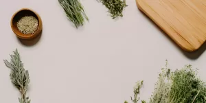 A drop of blood next to an iron-rich vegetable, symbolizing iron deficiency and herbal solutions.