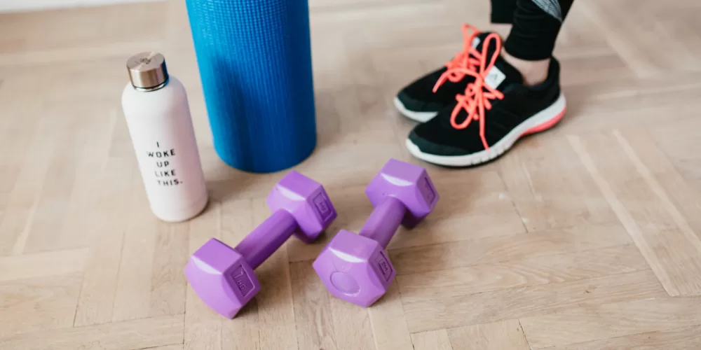 A woman demonstrating the Hundred, a fundamental move in Pilates Exercises for Beginners.
