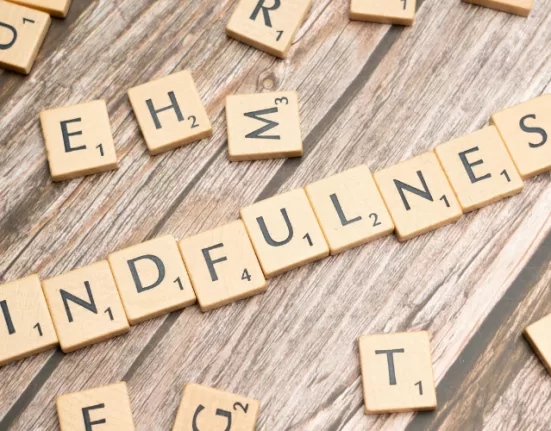 A person focusing on a single flower, a metaphor for Mindfulness Hacks for Overthinking